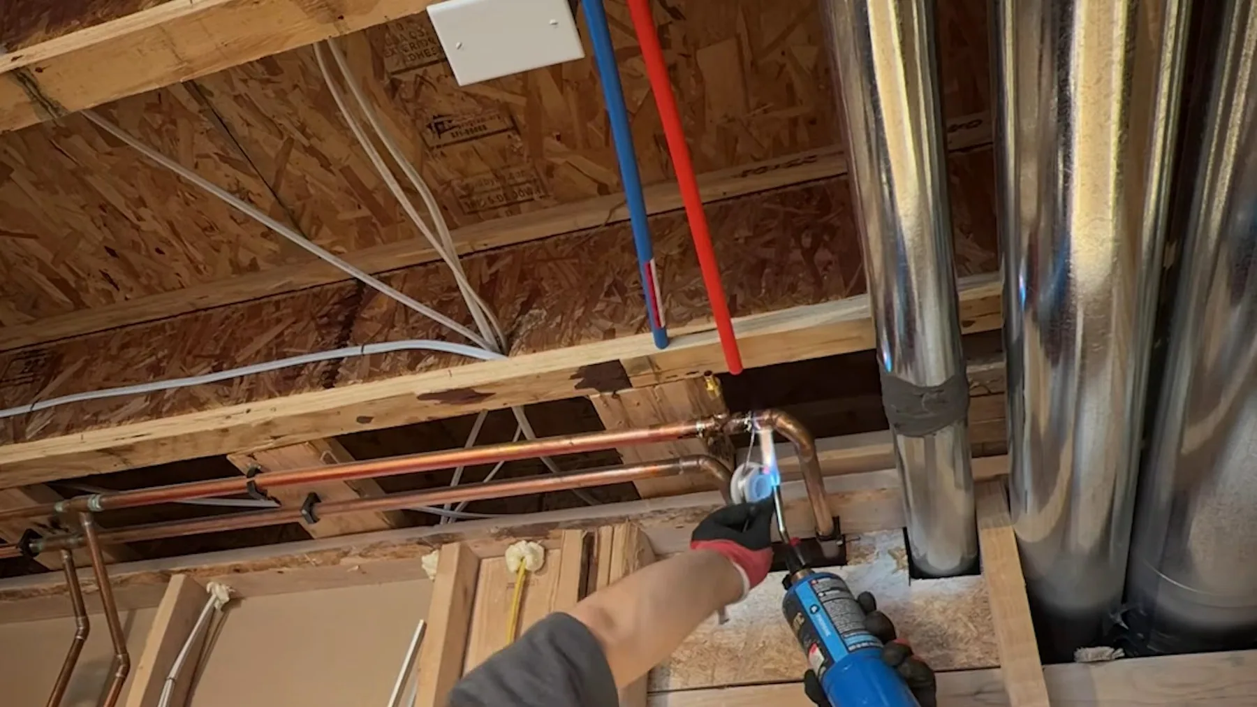 Framed basement wall with utility sink pipes for a Sherman-area plumbing job